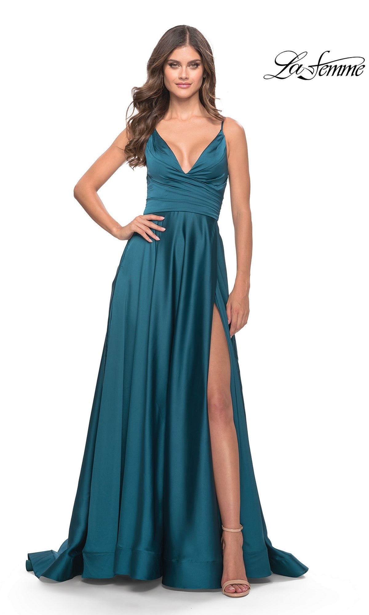 A woman wearing the La Femme V-Neck Long A-Line Prom Dress 31505 in teal satin, with a deep V-neck, ruched waist, thigh-high slit, and spaghetti straps stands with one hand on her hip. The La Femme 31505 logo appears in the corner.